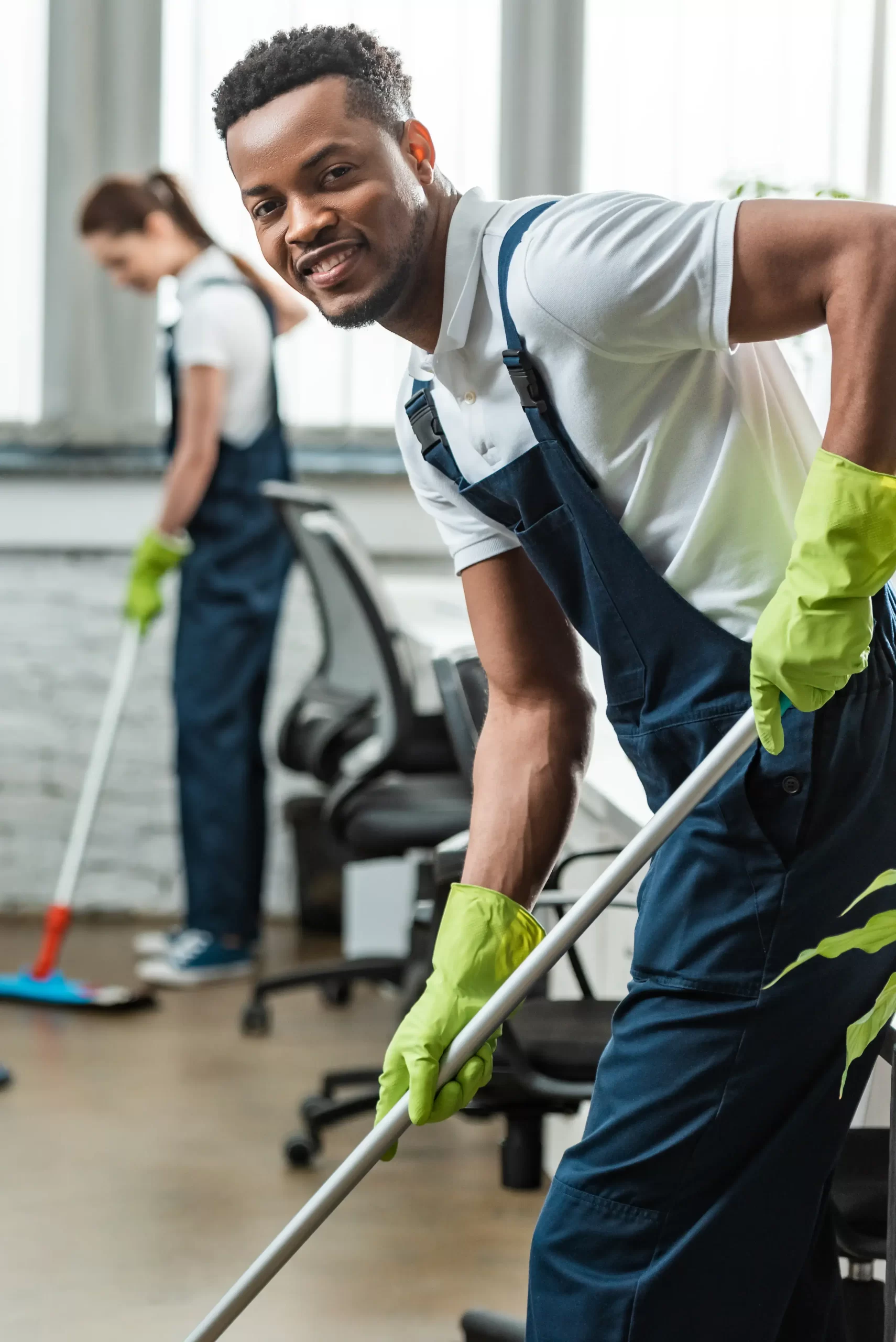 A cropped image of a working man smiling while cleaning
